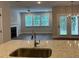 Kitchen island features granite countertops and stainless steel sink, connecting to a living room with a fireplace at 2409 Malster Ln, Lawrenceville, GA 30043