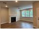 Bright living room with a fireplace, hardwood floors, and large windows offering abundant natural light at 2409 Malster Ln, Lawrenceville, GA 30043