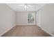 Bright bedroom featuring neutral walls, carpet, a ceiling fan, and a large window at 3200 Seven Pines Ct # 103, Atlanta, GA 30339
