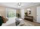 Serene bedroom with a large window, ceiling fan, and a view of the outdoors at 3200 Seven Pines Ct # 103, Atlanta, GA 30339
