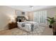 Inviting bedroom with a large window, ceiling fan, plush rug, and comfortable furnishings at 3200 Seven Pines Ct # 103, Atlanta, GA 30339