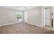 Spacious bedroom with neutral walls, carpet, ceiling fan, and natural light from the window at 3200 Seven Pines Ct # 103, Atlanta, GA 30339