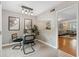 Open concept dining area with modern lighting, glass table, and view into the living room at 3200 Seven Pines Ct # 103, Atlanta, GA 30339
