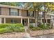 Charming townhome exterior with a welcoming front porch, stone accents, and lush landscaping at 3200 Seven Pines Ct # 103, Atlanta, GA 30339