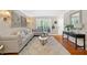 Bright living room featuring hardwood floors, large windows, and stylish contemporary decor at 3200 Seven Pines Ct # 103, Atlanta, GA 30339