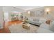 Open-concept living room with hardwood floors, comfortable seating, and a glimpse of the study area at 3200 Seven Pines Ct # 103, Atlanta, GA 30339