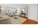 Bright living room featuring hardwood floors, stylish furniture, and ample natural light at 3200 Seven Pines Ct # 103, Atlanta, GA 30339