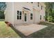 A backyard patio with a door and a view of the surrounding trees at 3902 Bouldercrest Se Rd, Ellenwood, GA 30294