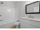 Bathroom features a shower and bath, a white vanity, and a framed mirror at 3902 Bouldercrest Se Rd, Ellenwood, GA 30294