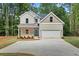 Charming two-story brick home with a well-manicured lawn and a welcoming blue front door at 3902 Bouldercrest Se Rd, Ellenwood, GA 30294