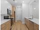 Modern kitchen featuring stainless steel appliances, and hardwood floors at 3902 Bouldercrest Se Rd, Ellenwood, GA 30294