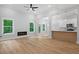 Open-concept living space with modern finishes, hardwood floors, and views of wooded backyard at 3902 Bouldercrest Se Rd, Ellenwood, GA 30294
