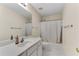 Full bathroom featuring tiled floors, a shower-tub combo, and a vanity at 1107 Carroll Ct, Norcross, GA 30071