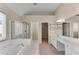 Vaulted bathroom with a jacuzzi tub, stand up shower, and walk-in closet at 1107 Carroll Ct, Norcross, GA 30071