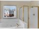 Bright bathroom with a jacuzzi tub and stand-up shower at 1107 Carroll Ct, Norcross, GA 30071