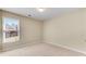 A cozy bedroom featuring neutral colors, and a large window offering ample natural light at 1107 Carroll Ct, Norcross, GA 30071