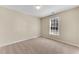 Bedroom with neutral walls, carpet, and natural light streaming through window at 1107 Carroll Ct, Norcross, GA 30071
