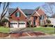 Beautiful brick home with a two-car garage and lush landscaping at 1107 Carroll Ct, Norcross, GA 30071