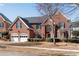 Stately brick home with two-car garage, manicured bushes and well-maintained yard at 1107 Carroll Ct, Norcross, GA 30071