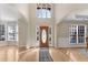 Elegant foyer with hardwood floors, high ceilings, and a front door with decorative glass at 1107 Carroll Ct, Norcross, GA 30071