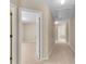 Neutral hallway with access to rooms, showing carpet flooring and ceiling lights at 1107 Carroll Ct, Norcross, GA 30071