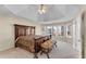 Main bedroom with a tray ceiling, carpeted floors, and many windows at 1107 Carroll Ct, Norcross, GA 30071
