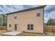 Exterior back of home featuring a tan siding, a patio, and fenced in backyard at 1262 Brookstone Cir, Conyers, GA 30012