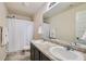 Bathroom featuring double sinks, a large mirror, and a shower with a white curtain at 1262 Brookstone Cir, Conyers, GA 30012