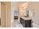 Primary bathroom featuring double sinks, a shower, a mirror, and a view into the bedroom at 1262 Brookstone Cir, Conyers, GA 30012