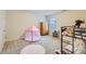 Bedroom with a bunk bed, pink tent, dresser, window, and a fluffy pink rug on neutral carpet at 1262 Brookstone Cir, Conyers, GA 30012