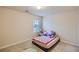 Bedroom showcasing a single bed, carpeted floors, and a window providing natural light at 1262 Brookstone Cir, Conyers, GA 30012