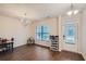 Bright dining area with wood floors and a window, featuring modern lighting and space for storage at 1262 Brookstone Cir, Conyers, GA 30012