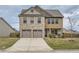 Charming two-story home featuring a brick and shingle facade with a two-car garage and well-manicured lawn at 1262 Brookstone Cir, Conyers, GA 30012