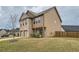 Spacious two-story home with brick accents and a two-car garage, complemented by a green lawn and young tree at 1262 Brookstone Cir, Conyers, GA 30012