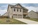 Well-maintained two-story home with brick and shingle siding, showcasing a two-car garage and landscaped front yard at 1262 Brookstone Cir, Conyers, GA 30012