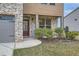 Inviting entryway with a dark wood door, brick facade, and landscaped garden bed and a 'Welcome' sign at 1262 Brookstone Cir, Conyers, GA 30012