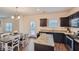 Stylish kitchen with granite countertops, dark wood cabinets, and stainless steel appliances, open to the dining area at 1262 Brookstone Cir, Conyers, GA 30012