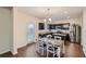 Modern kitchen and dining area with stainless steel appliances, granite countertops, and dark wood cabinets at 1262 Brookstone Cir, Conyers, GA 30012