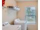 Bright laundry room featuring a washer, dryer, and shelving for storage at 1262 Brookstone Cir, Conyers, GA 30012