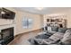 Cozy living room featuring a fireplace, large sectional sofa, and an open layout into the modern kitchen at 1262 Brookstone Cir, Conyers, GA 30012