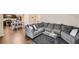 Bright living room showcasing an open floor plan with a large sectional sofa and an adjoining kitchen and dining area at 1262 Brookstone Cir, Conyers, GA 30012