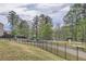 Community playground featuring play equipment, seating and walking trail with mature trees at 1262 Brookstone Cir, Conyers, GA 30012