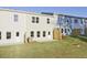 Townhome back exterior showing multiple windows, fenced yards, and well-maintained grass at 213 Admor Ln, Acworth, GA 30102