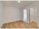 Bright bedroom features hardwood floors, fresh paint, and an adjacent closet at 213 Admor Ln, Acworth, GA 30102