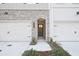Charming townhome entrance features a brick facade, arched doorway, and well-maintained landscaping at 213 Admor Ln, Acworth, GA 30102