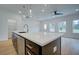 Kitchen island with dark cabinets and stainless steel appliances at 213 Admor Ln, Acworth, GA 30102