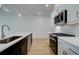 Modern kitchen featuring white cabinets, stainless steel appliances, and ample counter space at 213 Admor Ln, Acworth, GA 30102
