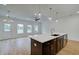 Modern kitchen island with sink, and an open layout leading to the living area at 213 Admor Ln, Acworth, GA 30102