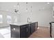 Spacious kitchen with a center island, hardwood floors, stainless steel appliances, and ample natural light at 213 Admor Ln, Acworth, GA 30102