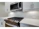 Close-up of modern kitchen featuring stainless steel microwave and gas cooktop at 213 Admor Ln, Acworth, GA 30102